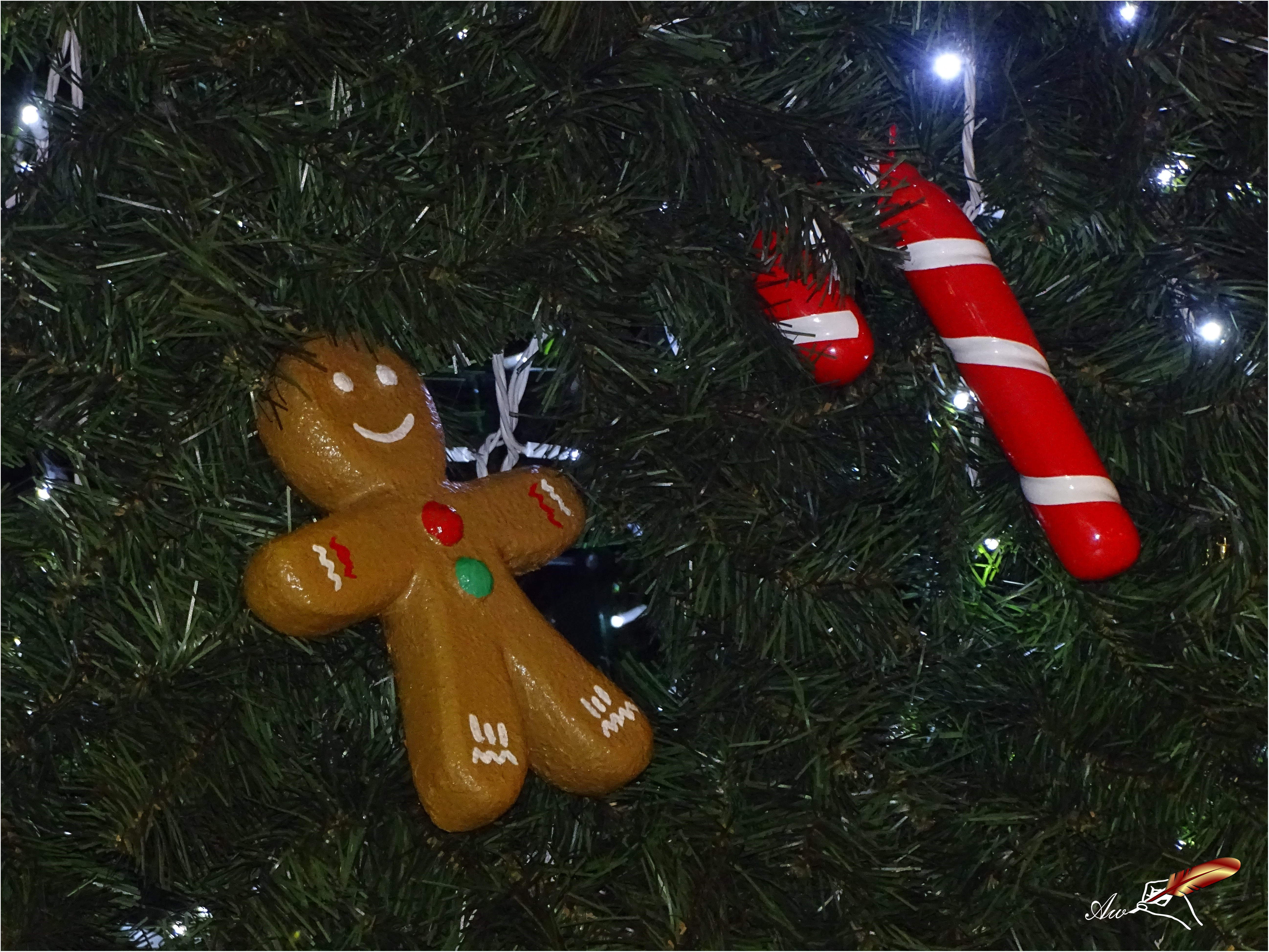 Gingerbread man and candy cane in Christmas tree - by Andrada Anitei